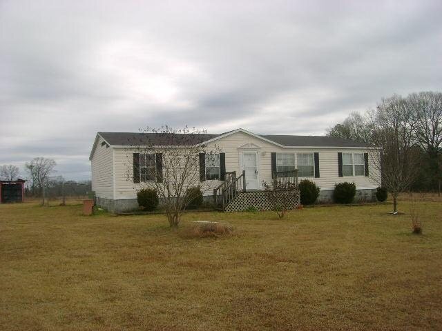 143 James English Road Cochran, GA 31014 - Photo 1 of 1 a view of a house with backyard and sitting area