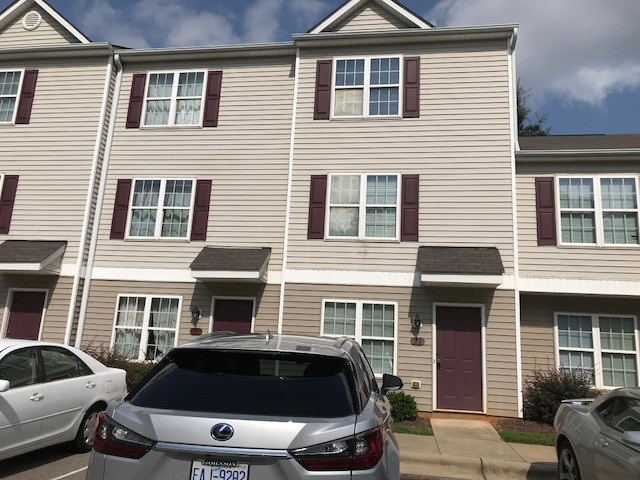 a front view of a house with parking space
