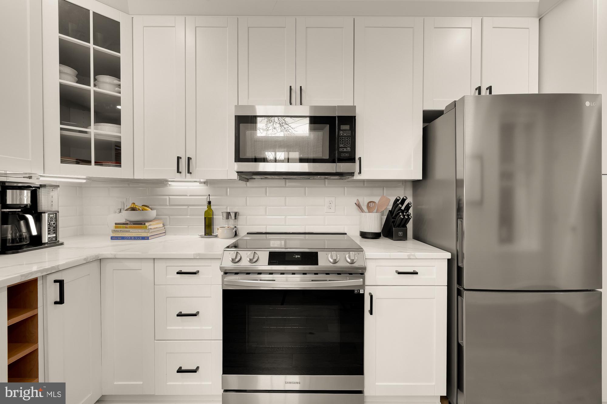 1834 6th Street Northwest Washington, DC 20001 - Photo 11 of 36 a kitchen with stainless steel appliances white cabinets and a refrigerator