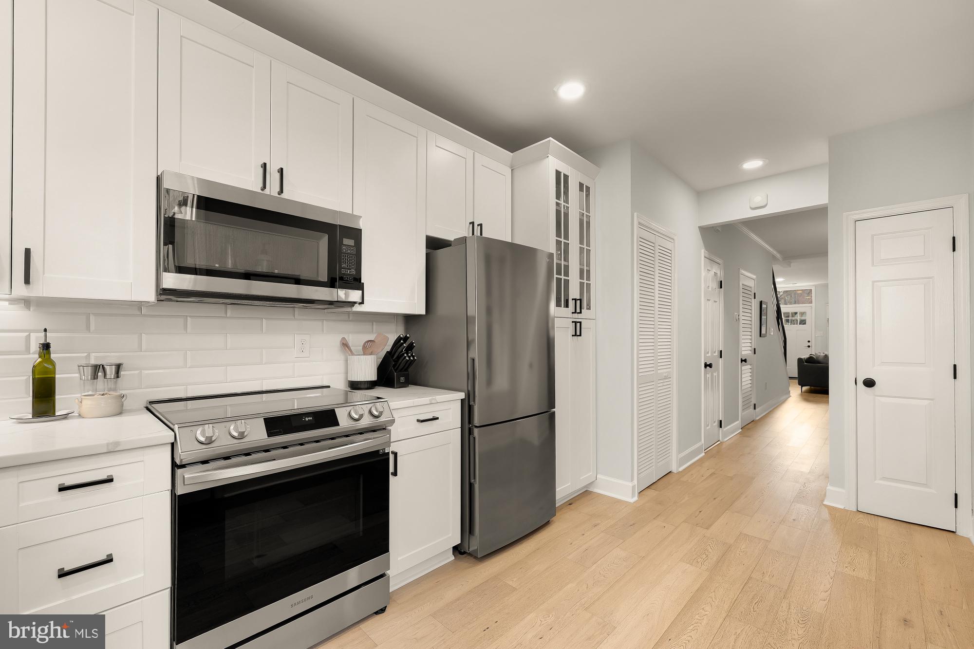 1834 6th Street Northwest Washington, DC 20001 - Photo 12 of 36 a kitchen with stainless steel appliances a stove a microwave and a refrigerator