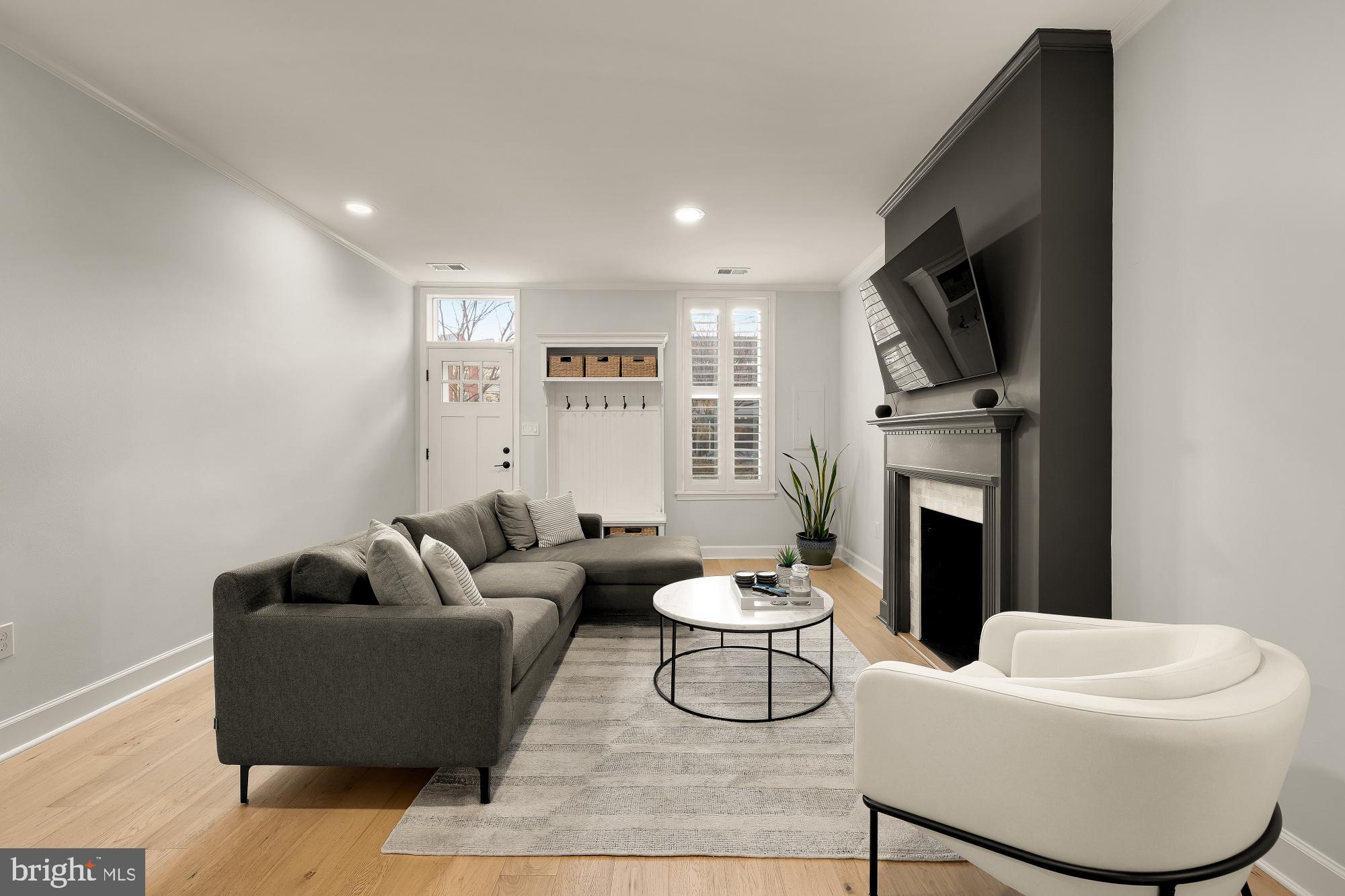 1834 6th Street Northwest Washington, DC 20001 - Photo 2 of 36 a living room with furniture a fireplace and a flat screen tv