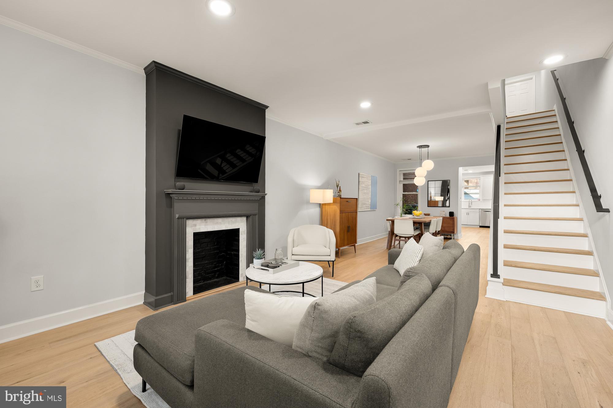 1834 6th Street Northwest Washington, DC 20001 - Photo 3 of 36 a living room with furniture a flat screen tv and a fireplace