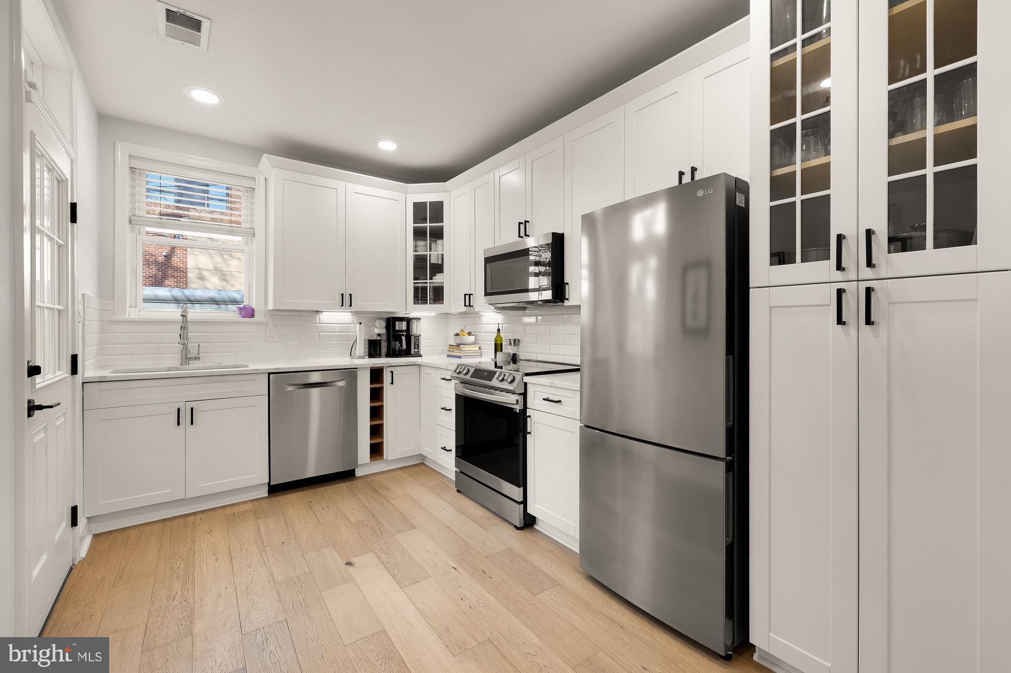 1834 6th Street Northwest Washington, DC 20001 - Photo 10 of 36 a kitchen with a refrigerator a sink and cabinets