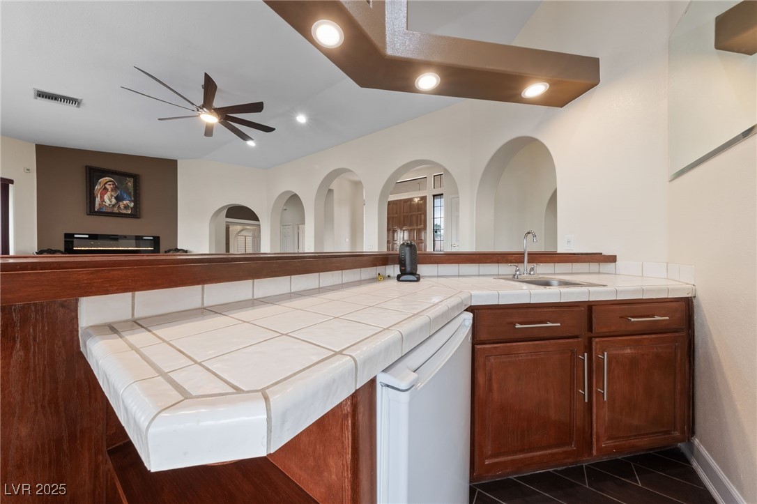 1056 Calico Ridge Drive Henderson, NV 89011 - Photo 67 of 67 Kitchen featuring open floor plan, visible vents, ceiling fan, dishwasher, and a sink