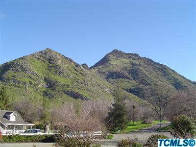 41085 Oak Ridge Drive Three Rivers, CA 93271 - Photo 2 of 6 a view of a large building with mountains in the background