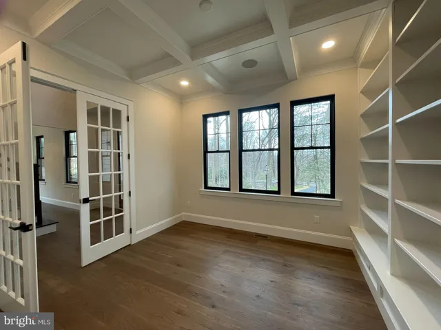 a view of a hallway to a livingroom with furniture