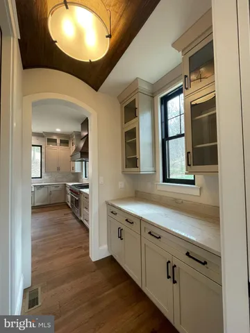 a kitchen with stainless steel appliances a refrigerator and a wooden floors