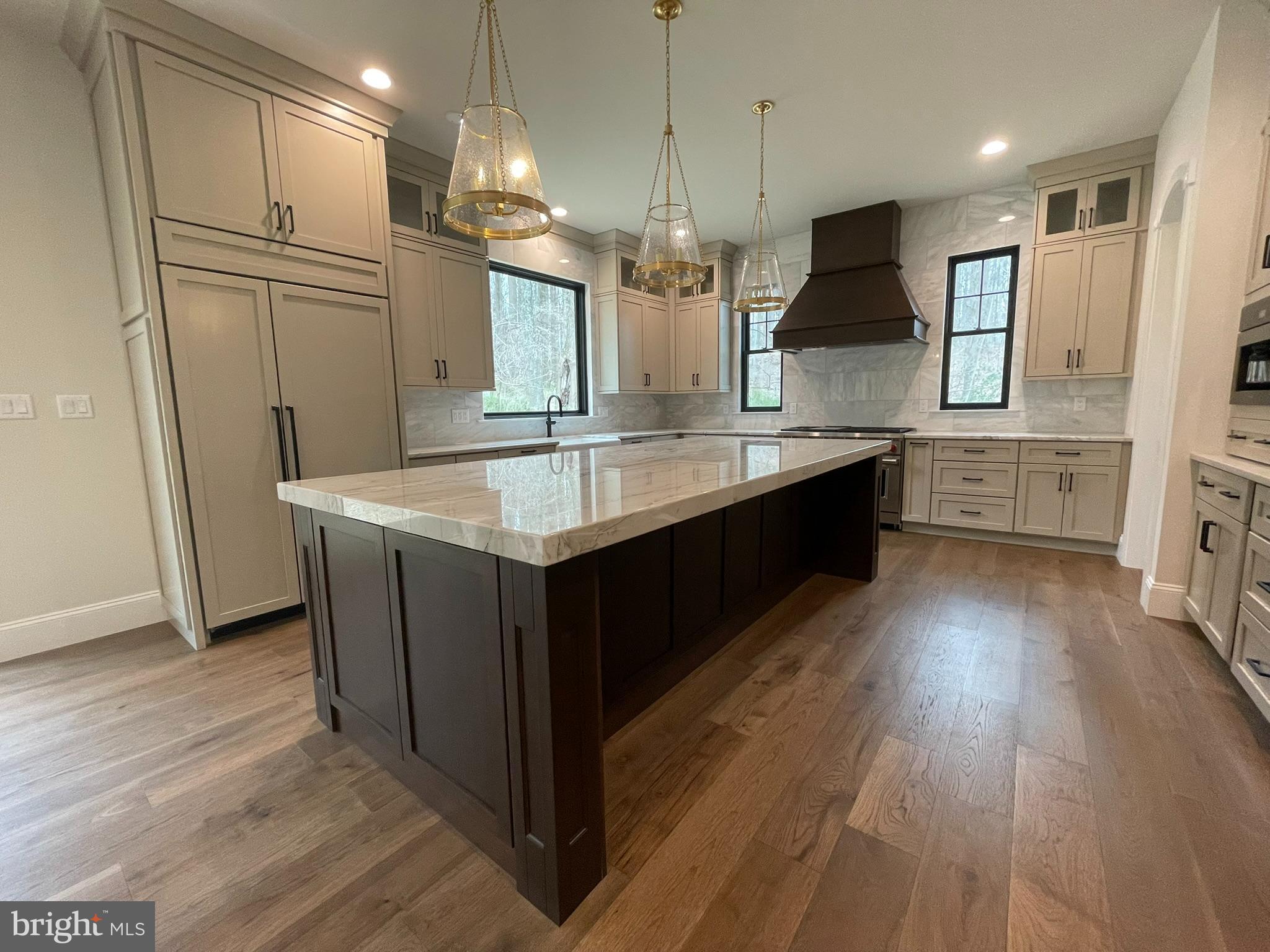 380 Zynn Road Downingtown, PA 19335 - Photo 16 of 53 a large kitchen with a large center island wooden floor stainless steel appliances and cabinets