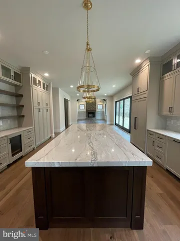 a view of empty room with wooden floor and fireplace