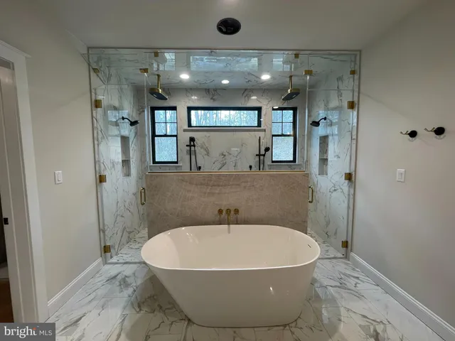 a hallway with stairs and wooden floor