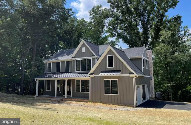 a front view of a house with windows and stairs