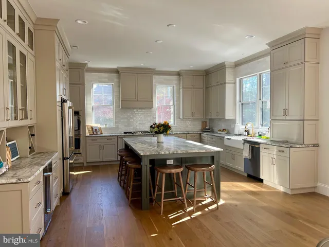 a kitchen with granite countertop a sink appliances counter top space and cabinets