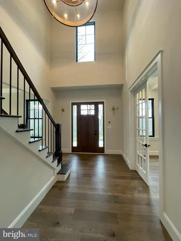 a view of an entryway with wooden floor and windows