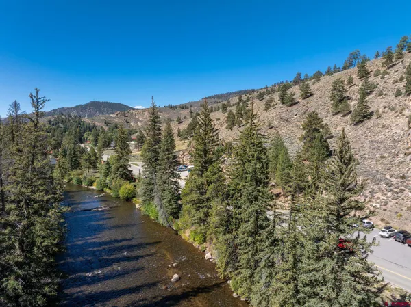 a view of mountains in the middle of a yard
