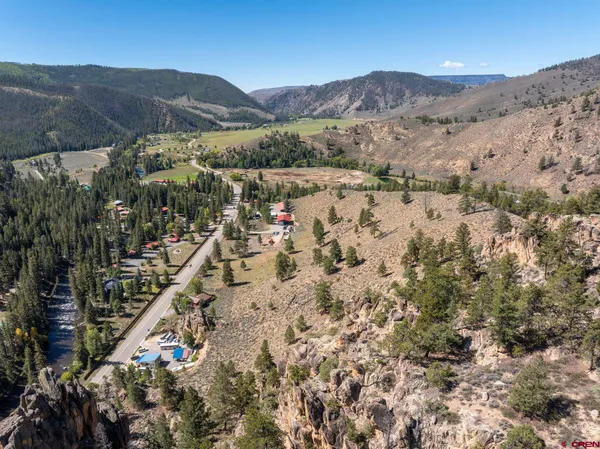 a view of a mountain with a field