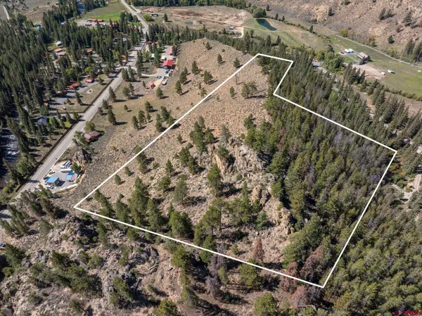 a view of a covered with trees in the background