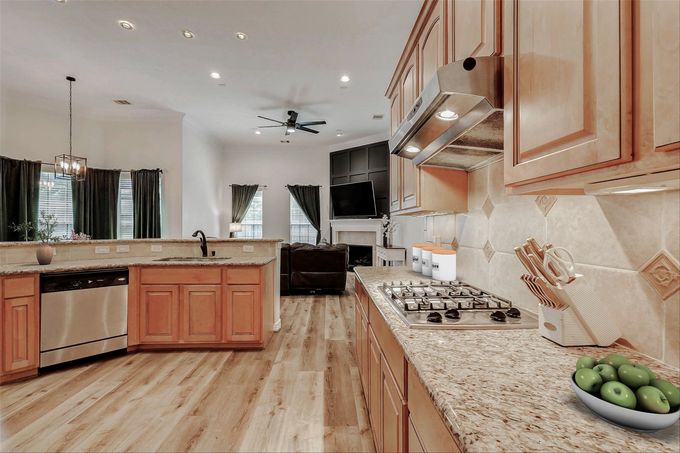 4403 Wickby Street Fulshear, TX 77441 - Photo 13 of 50 a kitchen with stainless steel appliances kitchen island granite countertop a stove a sink and a refrigerator