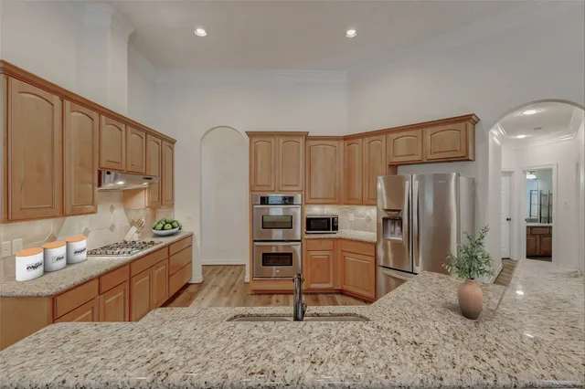 a kitchen with furniture a refrigerator and a sink