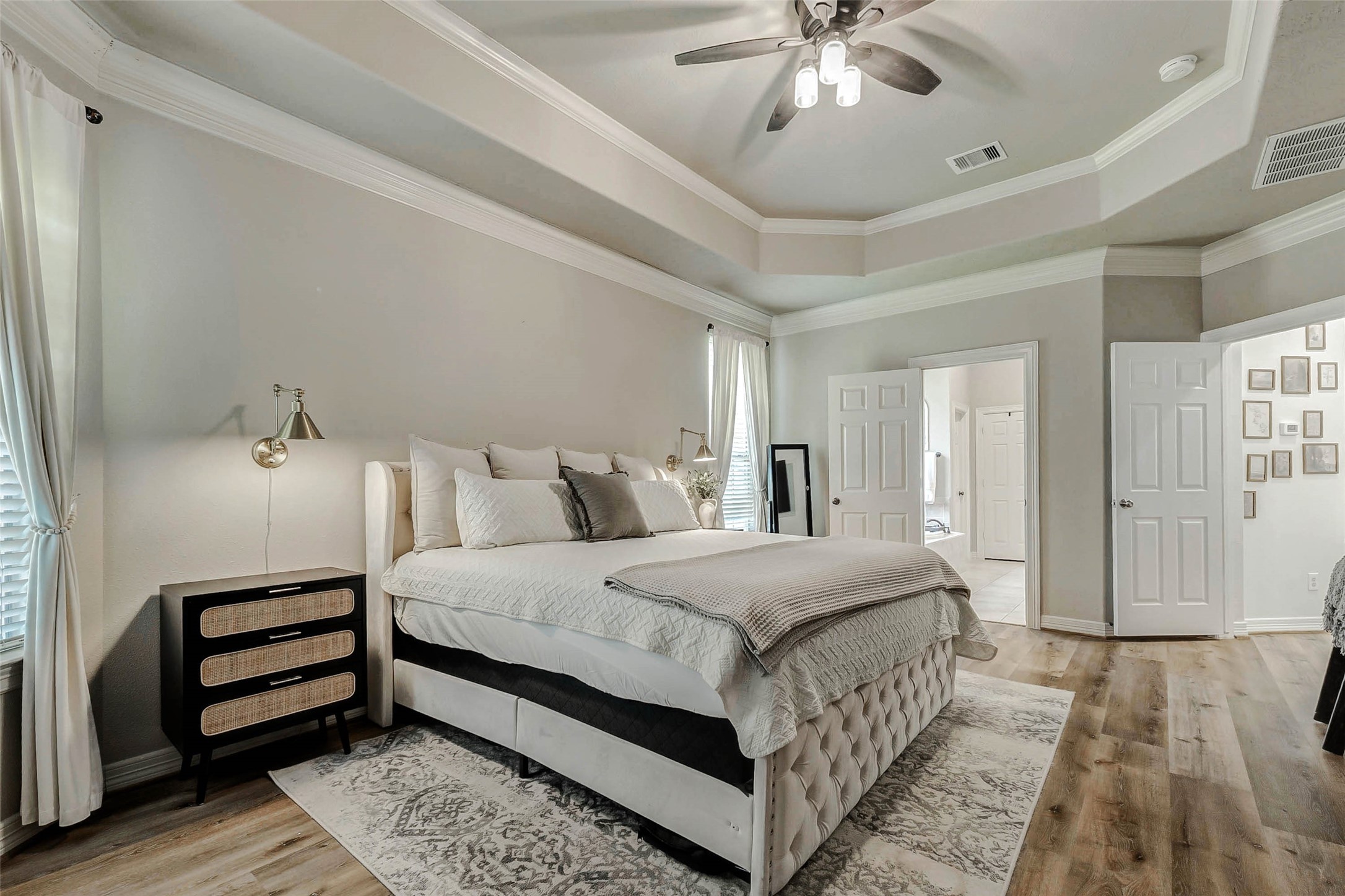 4403 Wickby Street Fulshear, TX 77441 - Photo 22 of 50 a spacious bedroom with a bed and a chandelier