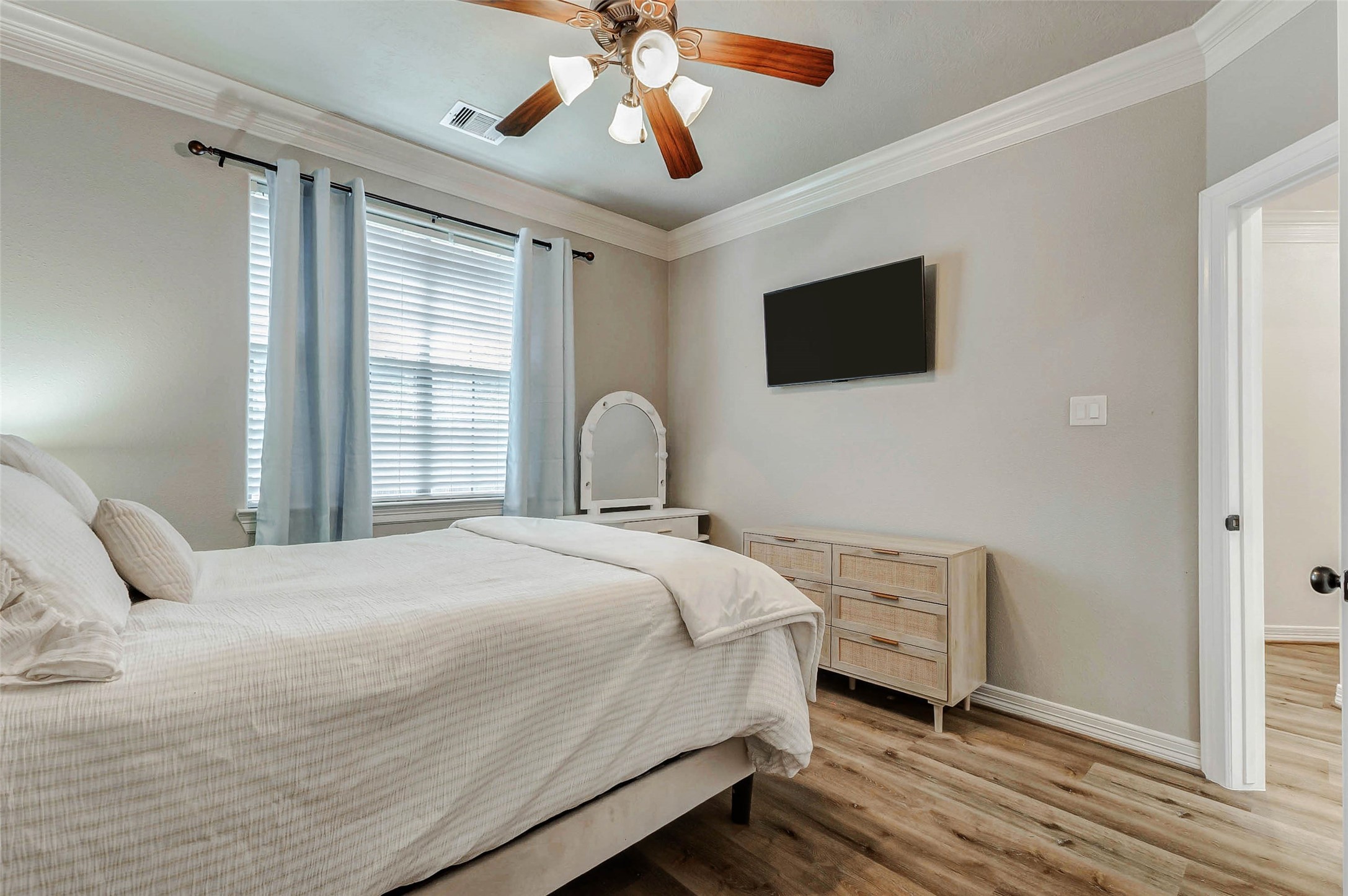 4403 Wickby Street Fulshear, TX 77441 - Photo 29 of 50 a bedroom with a bed and a chandelier