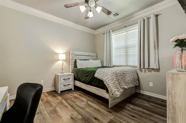 a bedroom with a bed and a chair