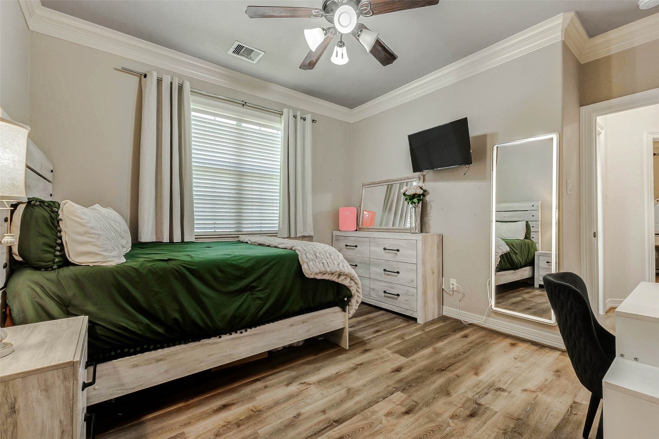 4403 Wickby Street Fulshear, TX 77441 - Photo 32 of 50 a bedroom with a bed flat screen tv and dresser