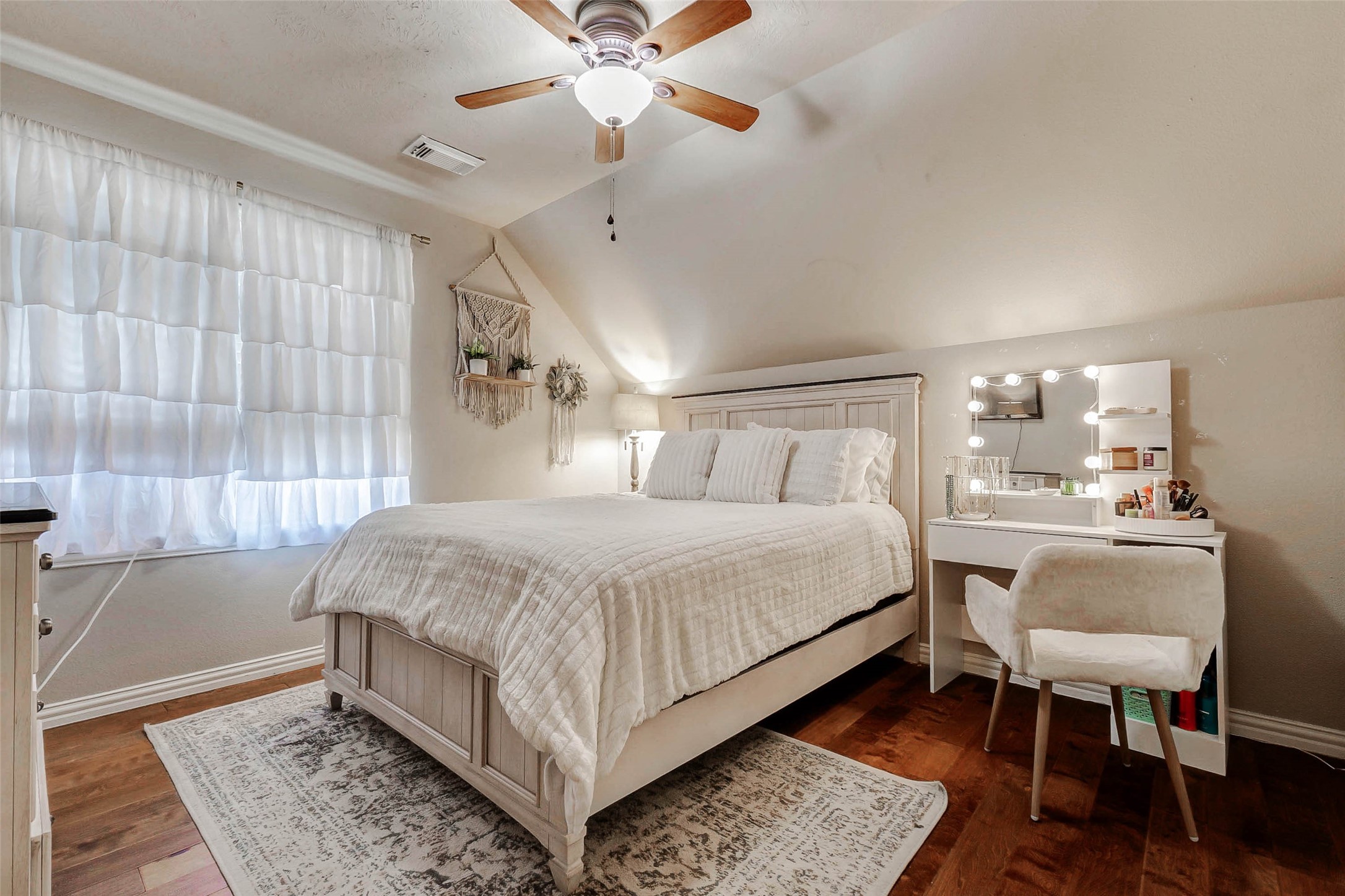 4403 Wickby Street Fulshear, TX 77441 - Photo 36 of 50 a bedroom with a large bed and a chandelier