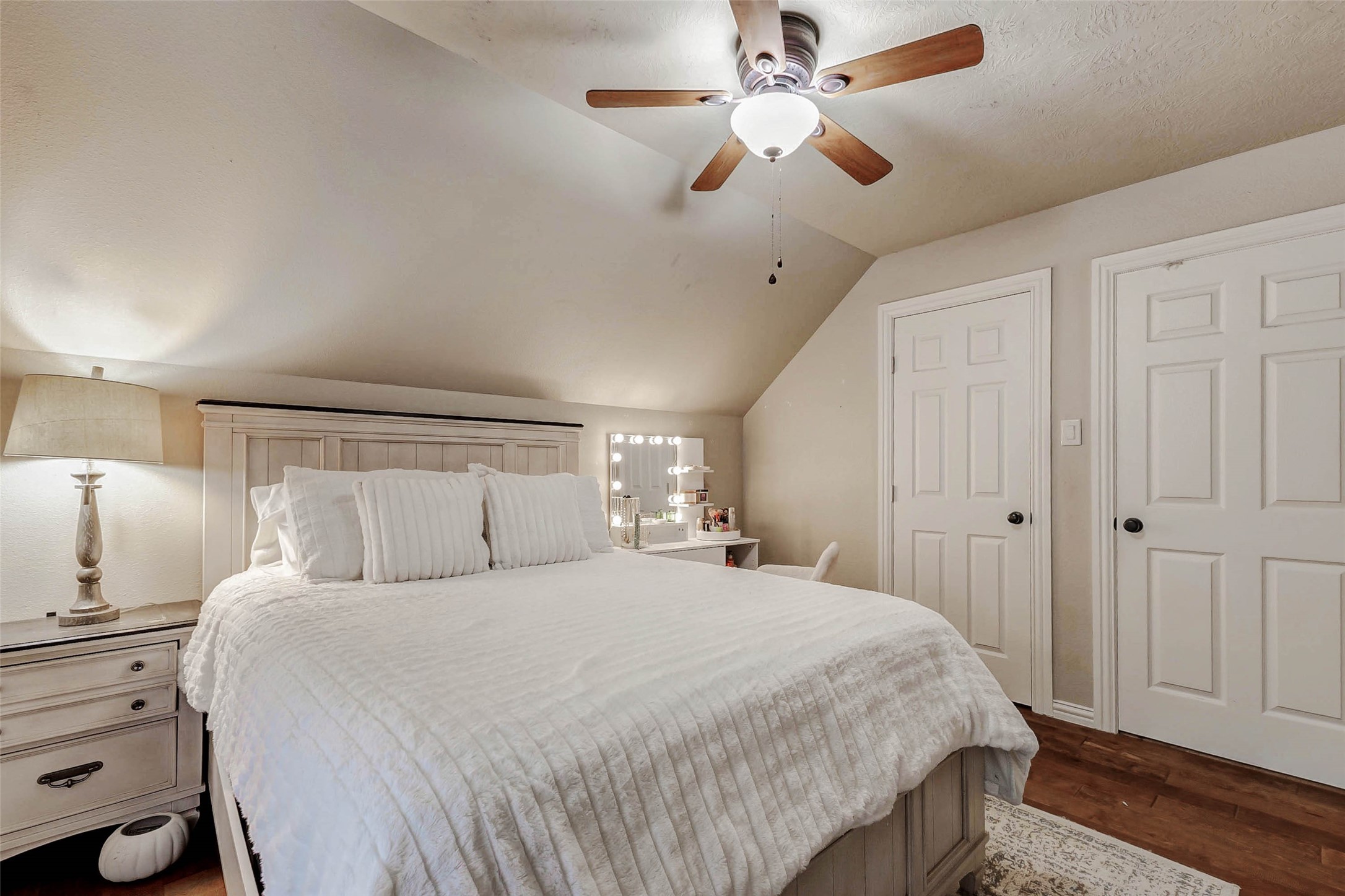 4403 Wickby Street Fulshear, TX 77441 - Photo 37 of 50 a bedroom with a large bed and a chandelier