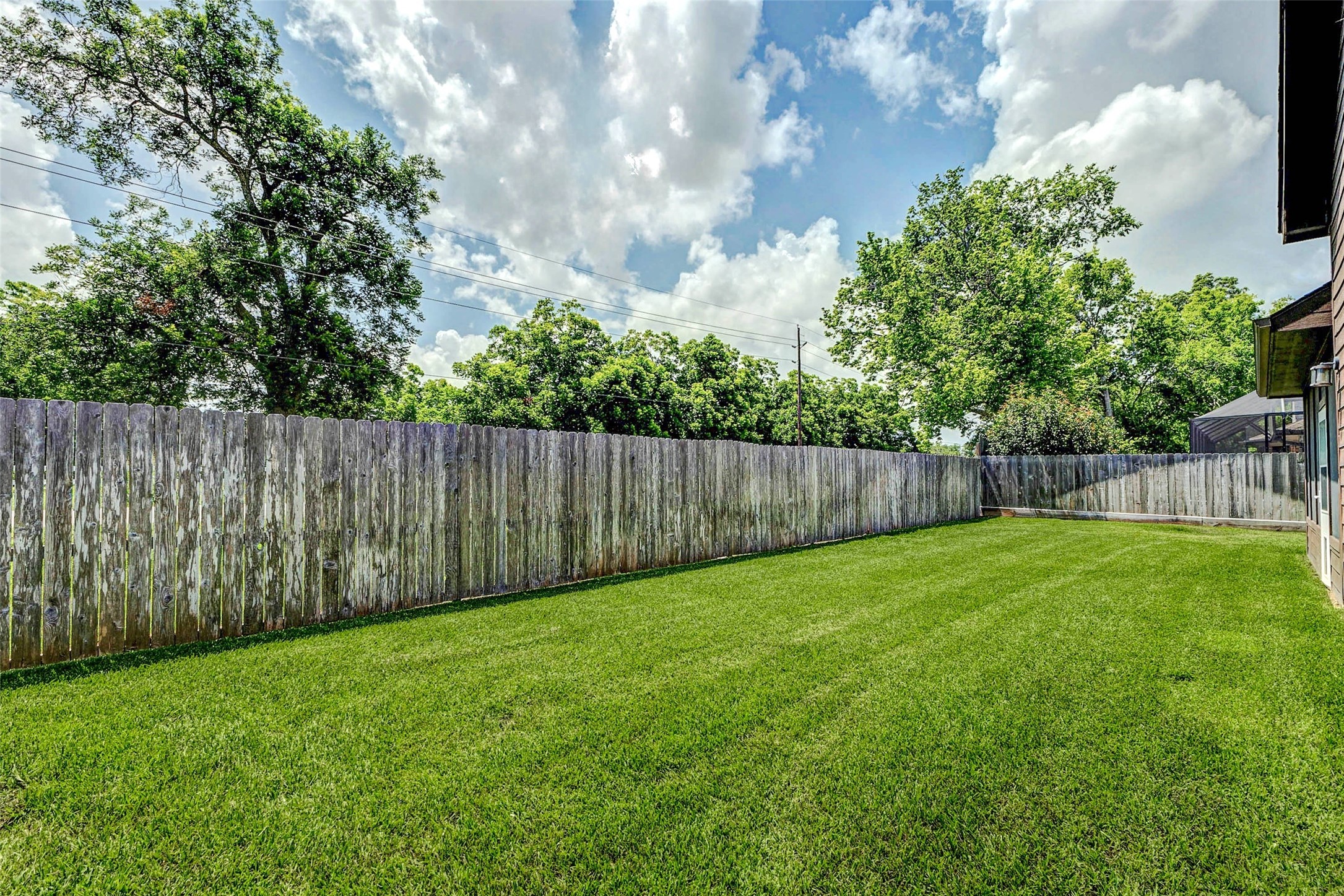 4403 Wickby Street Fulshear, TX 77441 - Photo 43 of 50 a view of a yard with wooden fence
