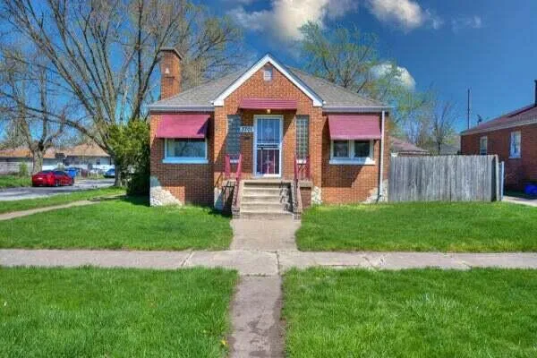 a front view of house with yard and green space