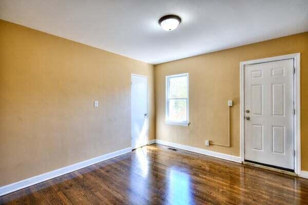 3701 Monroe Street Gary, IN 46408 - Photo 13 of 22 an empty room with wooden floor and windows