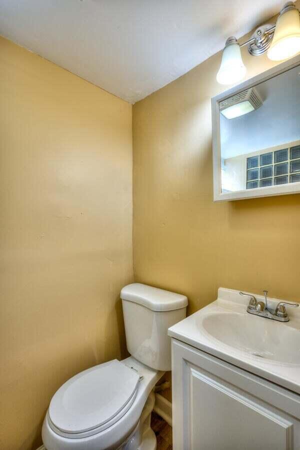 3701 Monroe Street Gary, IN 46408 - Photo 19 of 22 a white toilet sitting next to a blue sink and painted walls