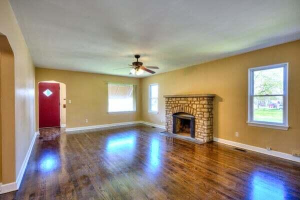3701 Monroe Street Gary, IN 46408 - Photo 2 of 22 a view of an empty room with wooden floor fireplace and a window