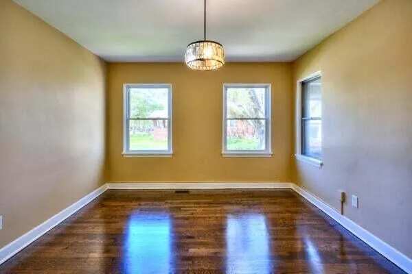 a view of room with window and wooden floor
