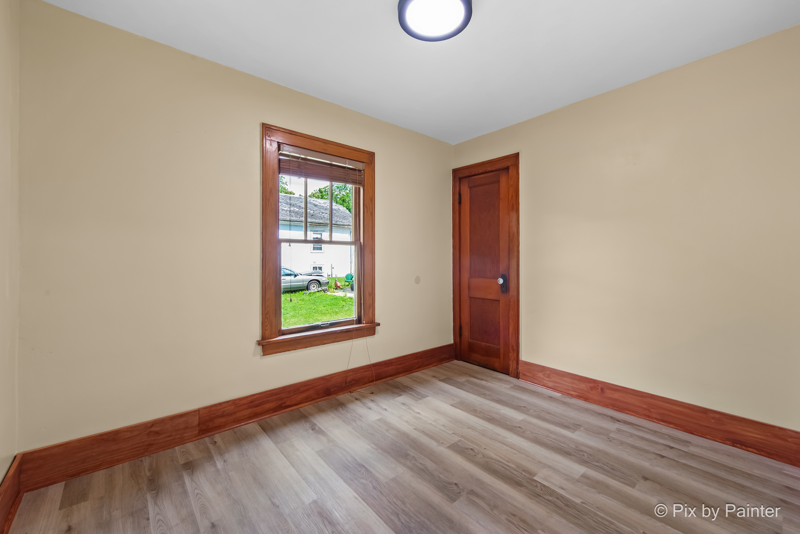 503 North River Road Fox River Grove, IL 60021 - Photo 12 of 48 a view of an empty room with wooden floor and a window