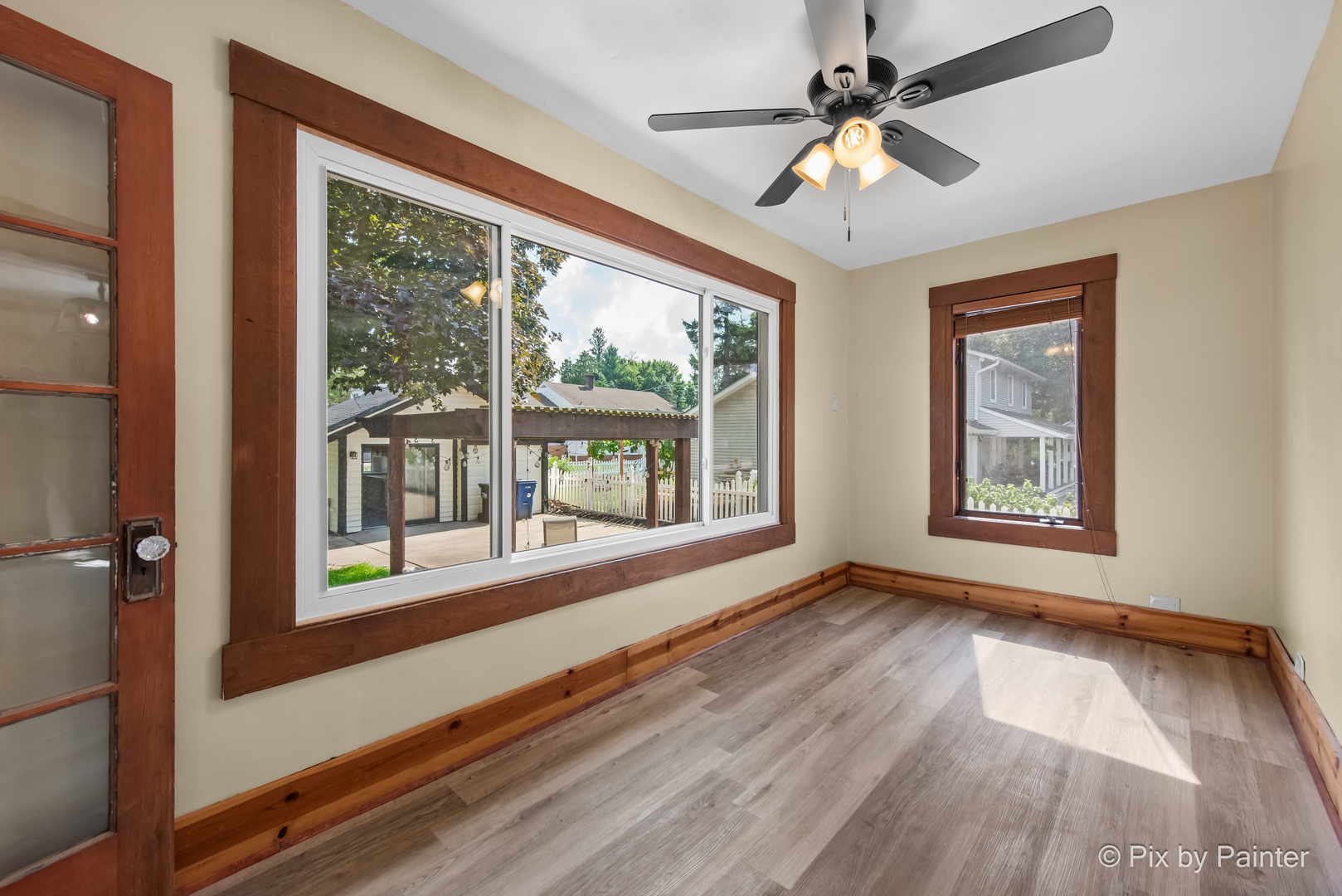 503 North River Road Fox River Grove, IL 60021 - Photo 15 of 48 a view of an empty room with window chandelier fan and wooden floor
