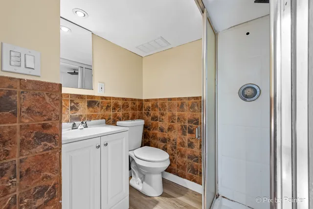 a bathroom with a sink toilet and shower