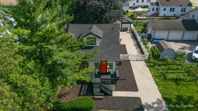 an aerial view of a house with a yard and potted plants