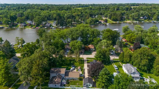 an aerial view of city lake and trees