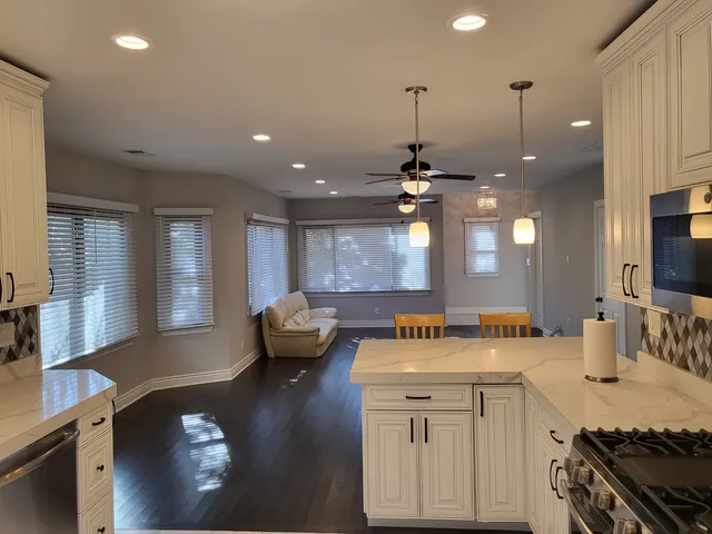 a kitchen with a sink stove and wooden floor