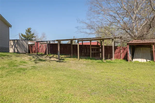 a view of a house with a yard and garage