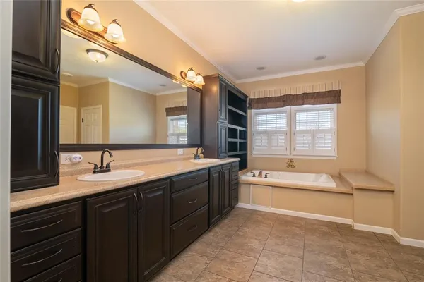 a spacious bathroom with a bathtub sink and mirror