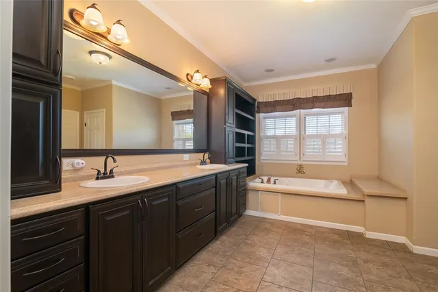 a spacious bathroom with a bathtub sink and mirror