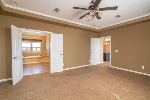 a view of an empty room and a ceiling fan