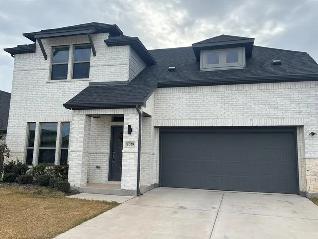 a front view of a house with garage
