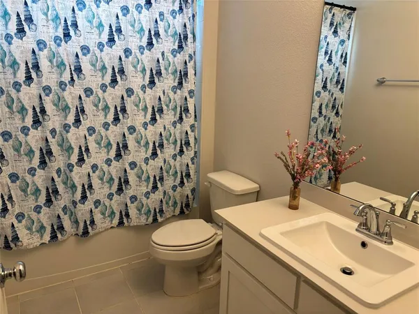 a large bed sitting in a bedroom next to a window