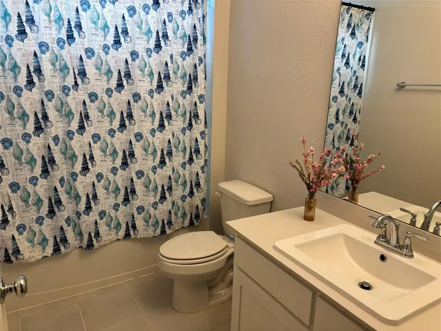 a large bed sitting in a bedroom next to a window