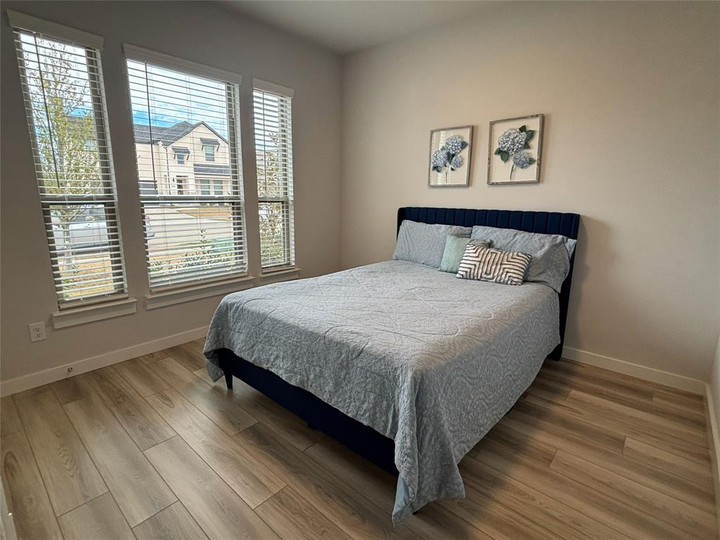 2029 Dovedale Drive Forney, TX 75126 - Photo 12 of 18 a large bed sitting in a bedroom next to a window