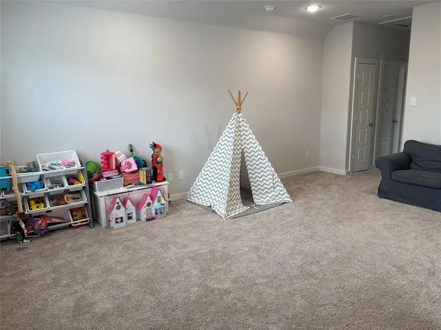 a living room with furniture and a rug