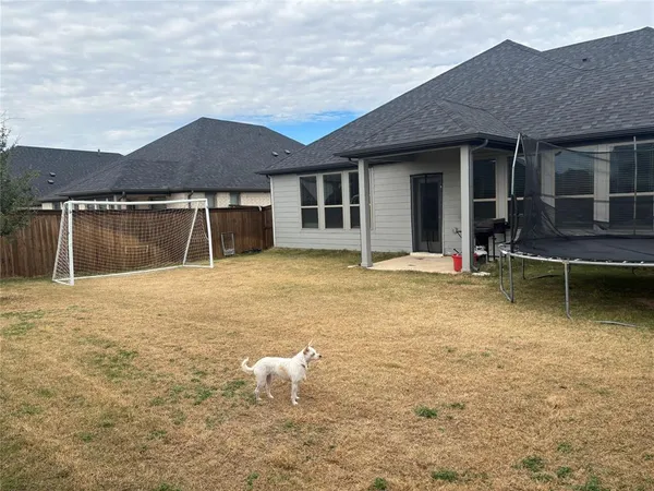 front view of a house with a yard and garage